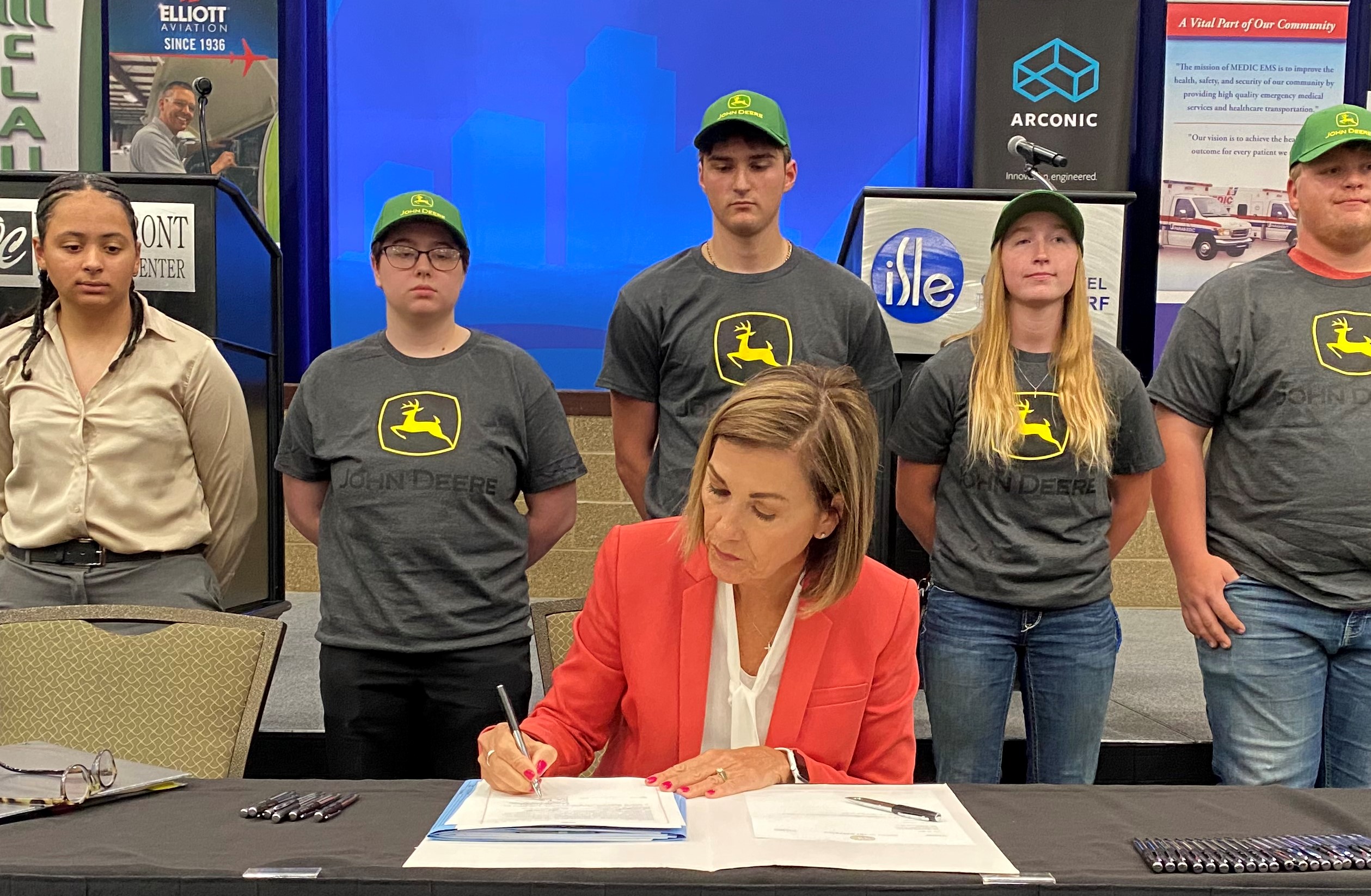 Governor Reynolds Signs Legislation Surrounded by Apprentices.